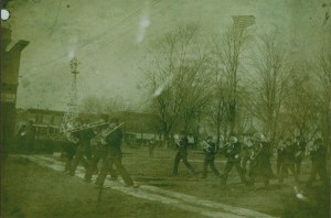 Band-Elmwood Band  E. Main St. on Rose St. Central Park in background with bandstand. There is windmill located current location Veteran's Memorial.